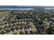 Aerial view of homes in a suburban neighborhood with a lake in the background at 1383 Buckeye Trace Blvd, Winter Haven, FL 33881