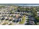 Aerial view showcases the home's location within a neighborhood, close to green spaces, ponds, and walking trails at 1383 Buckeye Trace Blvd, Winter Haven, FL 33881