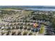 Aerial view of the neighborhood homes with a lake in the background, a home marked with a pin at 1383 Buckeye Trace Blvd, Winter Haven, FL 33881