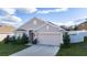 Charming one-story home featuring a two-car garage, neutral paint, and well-manicured front lawn at 1383 Buckeye Trace Blvd, Winter Haven, FL 33881