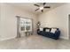 Comfortable living room features a ceiling fan, neutral walls, and a large window for natural light at 1383 Buckeye Trace Blvd, Winter Haven, FL 33881