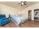 Relaxing main bedroom with ceiling fan, a comfy chair, and view to ensuite bathroom at 1383 Buckeye Trace Blvd, Winter Haven, FL 33881