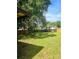 Expansive backyard featuring lush green grass and a privacy fence at 141 Varner Sw Dr, Winter Haven, FL 33880