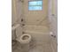White tiled bathroom featuring a soaking tub and modern fixtures at 1415 Zenith Pl, Orlando, FL 32808