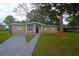 Charming single story home with brick facade and mature landscaping at 1415 Zenith Pl, Orlando, FL 32808