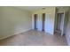 Bright bedroom featuring tile floors, folding closet doors and neutral wall paint at 15 Clear Way, Ocala, FL 34472