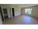 Bedroom featuring tile floors, a window and an open closet space at 15 Clear Way, Ocala, FL 34472