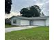 Cozy single-story home featuring a driveway and an attached garage and a grassy front yard at 15 Clear Way, Ocala, FL 34472