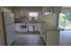 Functional kitchen with white appliances, ample counter space, and tile flooring at 15 Clear Way, Ocala, FL 34472