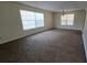 Large living room with carpet flooring, bright light, and ample space at 15 Clear Way, Ocala, FL 34472