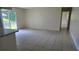 Open living space with tile flooring, sliding glass doors and access to other rooms at 15 Clear Way, Ocala, FL 34472