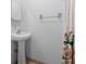 Bathroom featuring a pedestal sink, a shower with a curtain, and a decorative towel rack at 1506 Brookebridge Dr, Orlando, FL 32825