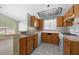 Efficient kitchen featuring wood cabinets, laminate countertops, and tile flooring at 1506 Brookebridge Dr, Orlando, FL 32825