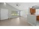 Light-filled living room featuring laminate flooring, ceiling fan, and breakfast bar at 1506 Brookebridge Dr, Orlando, FL 32825