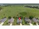 Suburban homes are surrounded by well maintained lawns, mature trees, and a large green field at 1525 Gants Cir, Kissimmee, FL 34744
