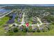 Aerial view of the neighborhood, showing homes, landscaping, and a nearby pond at 1525 Gants Cir, Kissimmee, FL 34744