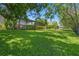 Expansive backyard with lush lawn and mature trees, providing a serene backdrop and privacy at 1525 Gants Cir, Kissimmee, FL 34744