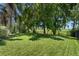 Lush backyard featuring a well-manicured lawn and mature trees, perfect for outdoor activities at 1525 Gants Cir, Kissimmee, FL 34744