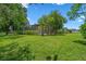 Expansive backyard with a screened lanai and lush landscaping offering privacy and relaxation at 1525 Gants Cir, Kissimmee, FL 34744