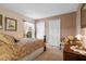 Cozy bedroom featuring neutral walls, hardwood floors, two closets, and a chair next to the side table at 1525 Gants Cir, Kissimmee, FL 34744