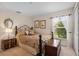 Comfortable bedroom with a double bed, hardwood floors, natural lighting, and antique decor at 1525 Gants Cir, Kissimmee, FL 34744