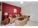 Guest bedroom with a large closet, red accent wall, and simple decor at 1525 Gants Cir, Kissimmee, FL 34744