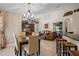 Bright dining room with elegant chandelier and access to the living area at 1525 Gants Cir, Kissimmee, FL 34744