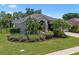 Beautiful single-story home with lush landscaping, a well-manicured lawn, and charming curb appeal at 1525 Gants Cir, Kissimmee, FL 34744