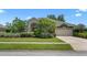 Attractive home with a two-car garage, mature trees, and vibrant landscaping at 1525 Gants Cir, Kissimmee, FL 34744