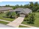 Well-manicured front yard and long driveway leading to a charming home with an attached two-car garage at 1525 Gants Cir, Kissimmee, FL 34744
