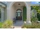 Welcoming front porch with seating and charming details, framed by lush landscaping at 1525 Gants Cir, Kissimmee, FL 34744