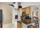 Bright kitchen featuring granite countertops, wooden cabinetry, and stainless steel appliances at 1525 Gants Cir, Kissimmee, FL 34744