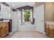 Luxurious bathroom with a garden tub, glass shower, tile flooring, and plenty of vanity space at 1525 Gants Cir, Kissimmee, FL 34744