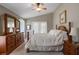 Spacious main bedroom with a vaulted ceiling, two large windows, and coordinating wood furniture at 1525 Gants Cir, Kissimmee, FL 34744