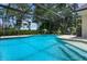 Expansive pool within a screened enclosure, ideal for Gathering fun and outdoor living at 1525 Gants Cir, Kissimmee, FL 34744