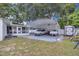 Spacious backyard featuring a carport, shed, and screened-in patio for outdoor living at 1710 Thor Ave, Apopka, FL 32703