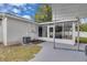 Home's exterior has a carport, an AC unit, and access to the enclosed sunroom at 1710 Thor Ave, Apopka, FL 32703