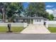 Landscaped front yard featuring green lawn, driveway, and white picket fence enhancing curb appeal at 1710 Thor Ave, Apopka, FL 32703