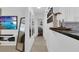 Hallway view with modern mirrors and decor leading to a bedroom and updated kitchen at 1710 Thor Ave, Apopka, FL 32703