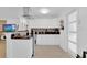 Bright kitchen featuring white cabinetry, granite counters and a stainless steel range and hood at 1710 Thor Ave, Apopka, FL 32703