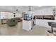 Bright, open kitchen featuring white cabinets, stainless steel appliances, and a breakfast bar, leading to the living room at 1710 Thor Ave, Apopka, FL 32703