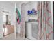 Functional laundry room with modern appliances tucked behind a stylish privacy curtain at 1710 Thor Ave, Apopka, FL 32703