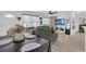Well-lit living room and dining area with tile floors, modern decor, and comfortable seating at 1710 Thor Ave, Apopka, FL 32703