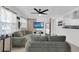 Comfortable living room with bright natural light, stylish sofas, and a mounted flat screen television at 1710 Thor Ave, Apopka, FL 32703