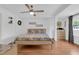 Spacious main bedroom with wood laminate floors, ceiling fan, and bright natural light at 1710 Thor Ave, Apopka, FL 32703