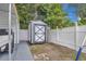 Backyard shed has a white exterior and is adjacent to a fenced yard for storage at 1710 Thor Ave, Apopka, FL 32703