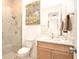 Bathroom featuring a glass shower and a modern vanity with artwork at 1855 Treasure Cv, Kissimmee, FL 34747