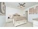 Primary bedroom with a ceiling fan, neutral colors, and an ensuite bathroom at 1855 Treasure Cv, Kissimmee, FL 34747