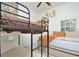 Bedroom showcasing a bunk bed and a cozy double bed with built in drawers at 1855 Treasure Cv, Kissimmee, FL 34747