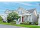 Inviting home featuring a charming front porch, well-maintained landscaping, and a freshly cut lawn at 1855 Treasure Cv, Kissimmee, FL 34747